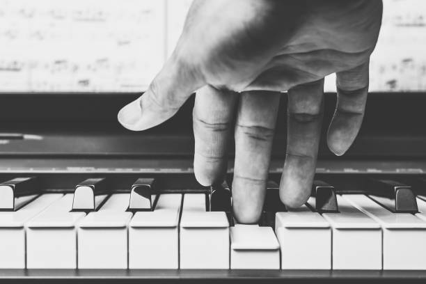 male musician hands playing on piano keys