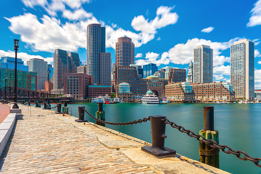 Boston skyline in sunny summer day, view from harbor on downtown, Massachusetts, USA.