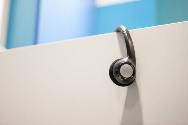 istock Headphones hanging on panel, call center 700221390