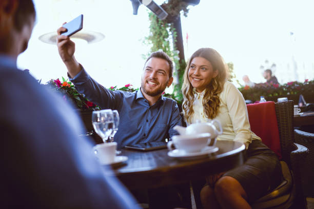istock Happy Smiling Couple Taking Selfie in a Cafe Restaurant 700234770