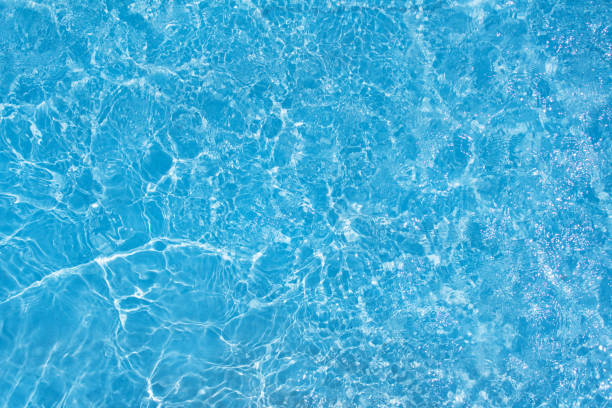 istock summer-Sparkling wave of blue swimming pool water 700235284