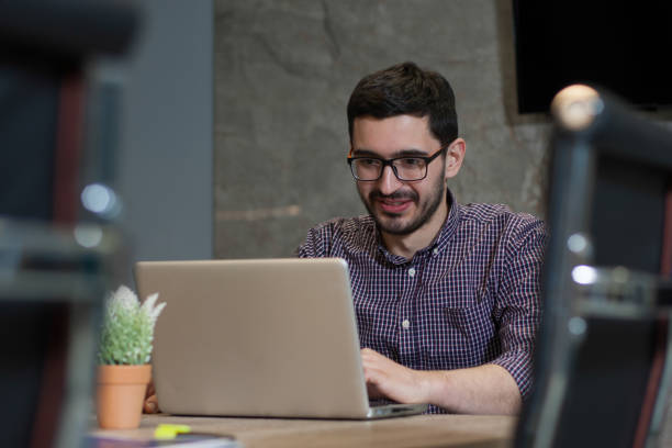 istock Young businessman is working on his laptop in office 700250082