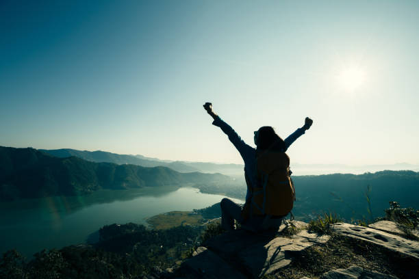 istock Successful woman backpacker on beautiful mountain top 700250298