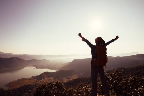 istock Successful woman backpacker on beautiful mountain top 700250764