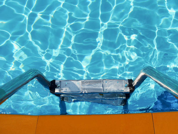 istock Ladder in swimming pool. 700250774