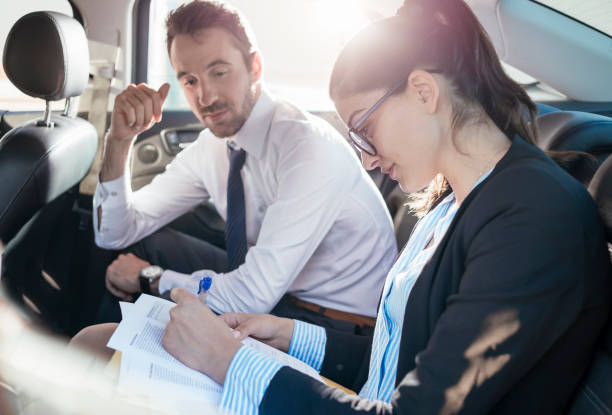 istock coworkers doing some paperwork in the car 700253488