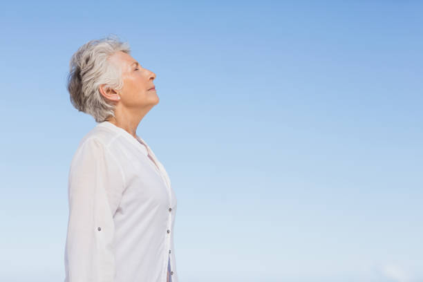 istock Senior woman relaxing on the beach 700253934