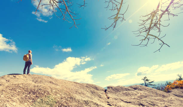 istock Man walking on the edge of a cliff 700257266