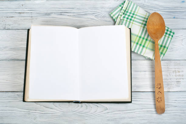 istock Recipe cook blank book on wooden background, spoon, rolling pin, checkered tablecloth 700262050