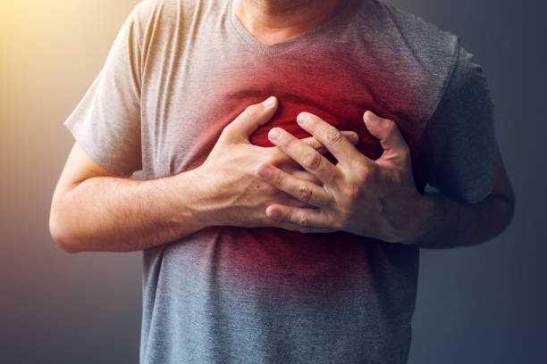 Adult male with heart attack or heart burn condition stock photo