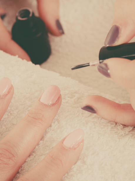 istock Woman in beauty salon getting manicure done. 700263290