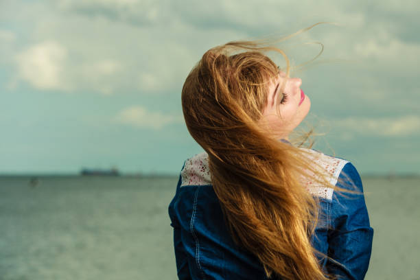 Summer freedom happiness concept. Girl long blonde hair enjoying summer breeze by seaside