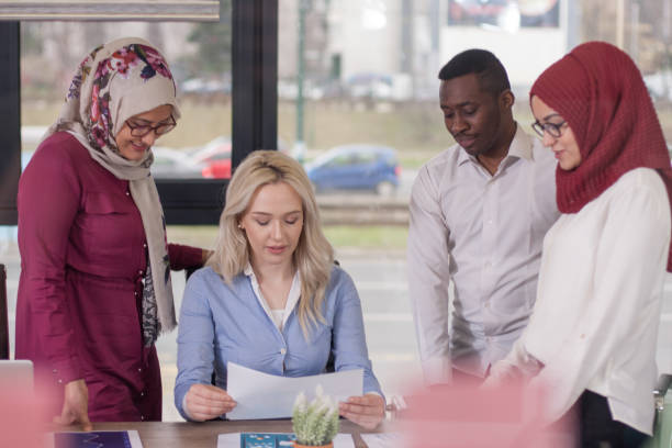 istock Multiethnic group of young business persons at office 700277202