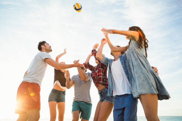 istock Friends trying to catch volley ball 700287016