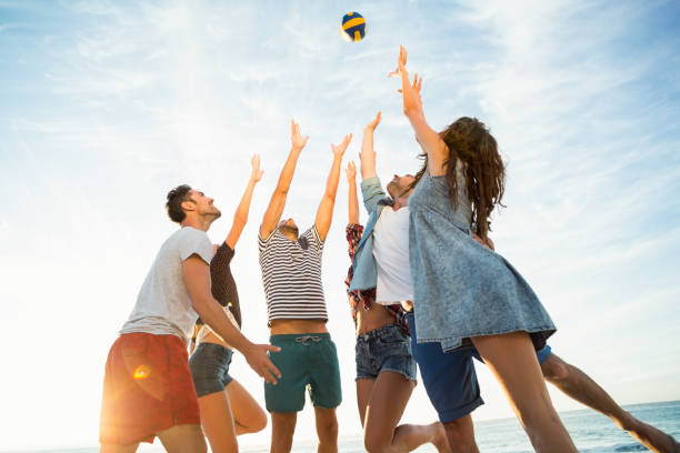istock Friends trying to catch volley ball 700287138
