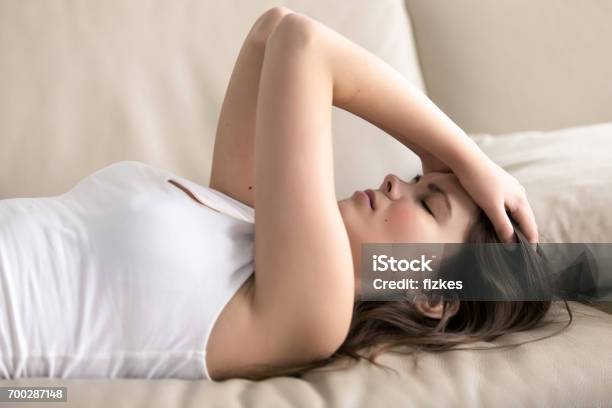 Young Woman Suffering Of Headache Or Migraine Stock Photo - Download Image Now - Exhaustion, Chronic Illness, Tired