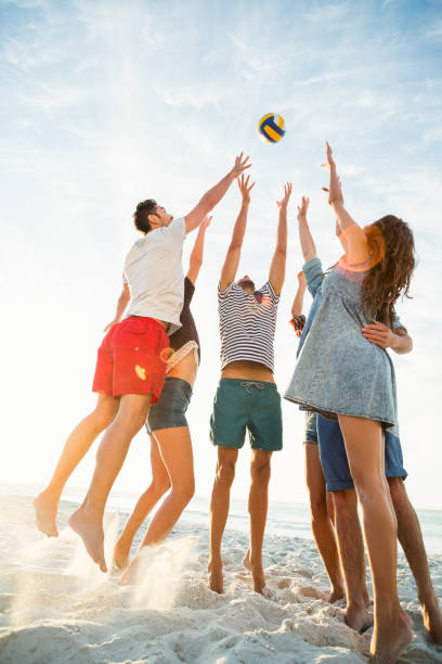 istock Friends trying to catch volley ball 700287178