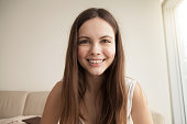 Emotive headshot portrait of smiling young woman