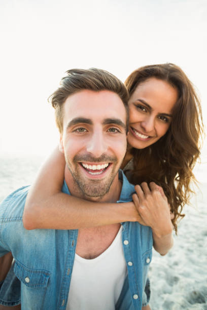 istock Boyfriend giving piggy back to girlfriend 700287358