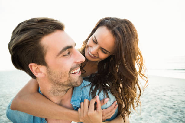 istock Boyfriend giving piggy back to girlfriend 700287364