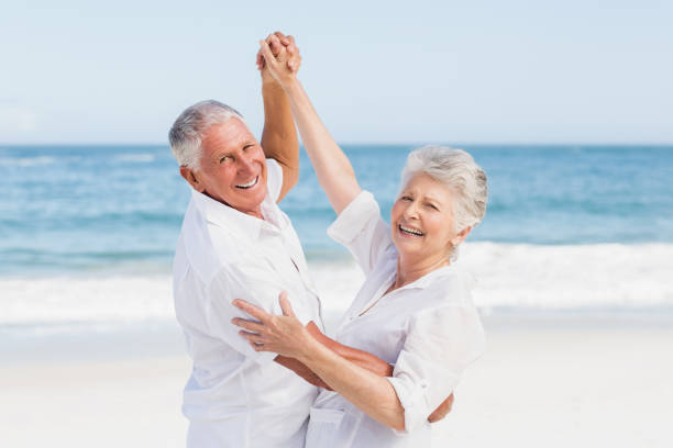 istock Senior couple dancing on the beach 700287474