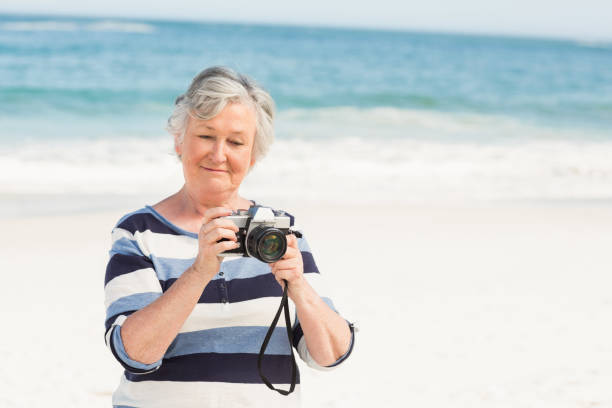 istock Senior woman taking picture 700287624
