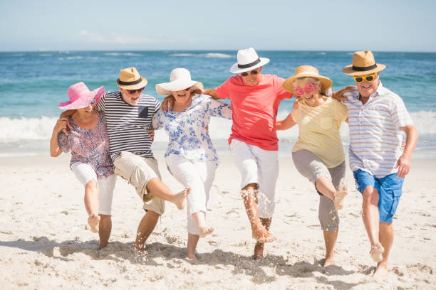 istock Senior friends dancing on the beach 700289906