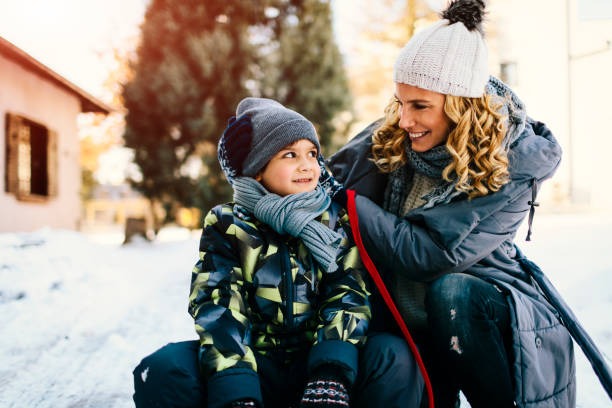 istock Mother and Son Having Fun Outdoors At Winter 700290254