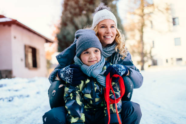 istock Mother and Son Having Fun Outdoors At Winter 700290478