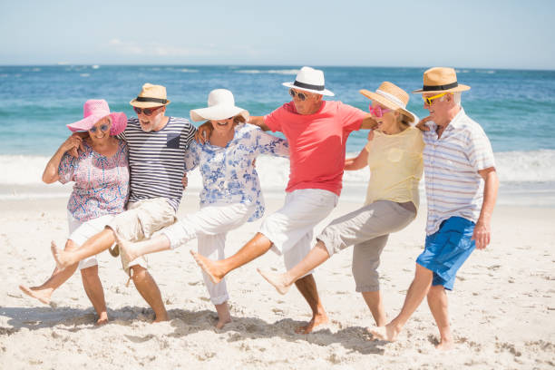 istock Senior friends dancing on the beach 700296436