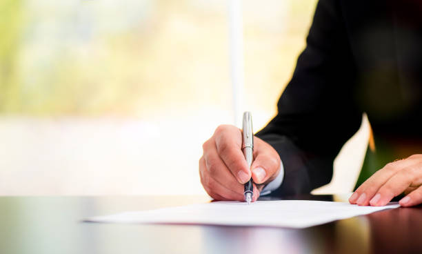 istock Businessman Is Signing A Legal Document In Office 700296732