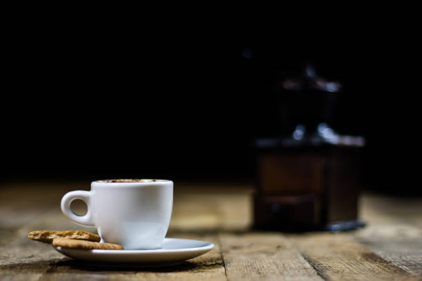 istock Freshly brewed coffee in cups on a wooden table with a milling mill 700297000