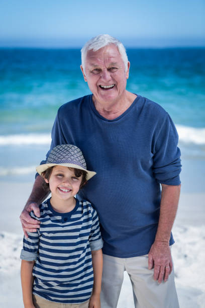 istock Cute boy embracing his grandfather 700297062