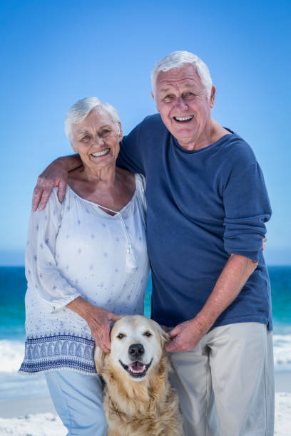 istock Cute mature couple petting their dog 700298228