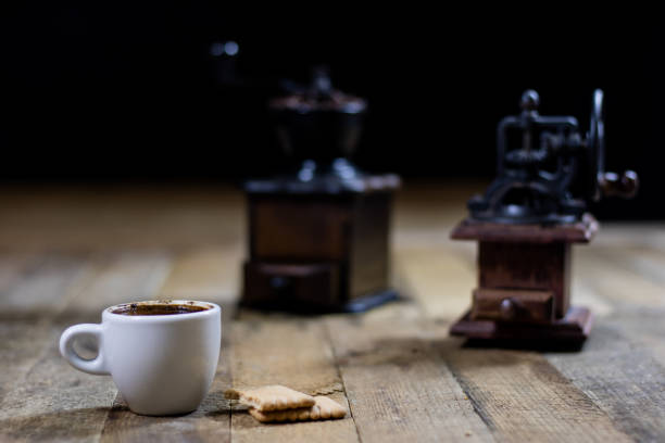istock Freshly brewed coffee in cups on a wooden table with a milling mill 700303678