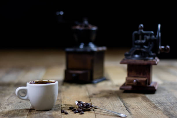 istock Freshly brewed coffee in cups on a wooden table with a milling mill 700304052