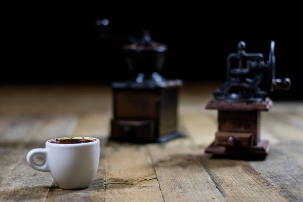 istock Freshly brewed coffee in cups on a wooden table with a milling mill 700304068