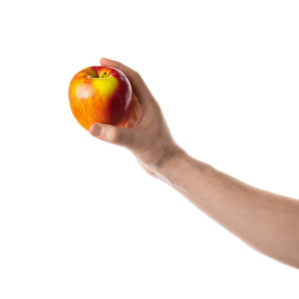 istock Apple. Male hand holding red apple. 700314348