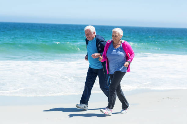 istock Cute mature couple running together 700316566