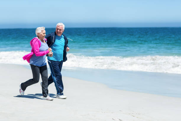 istock Cute mature couple running together 700318628