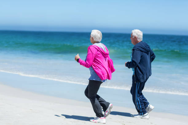 istock Cute mature couple running together 700318636