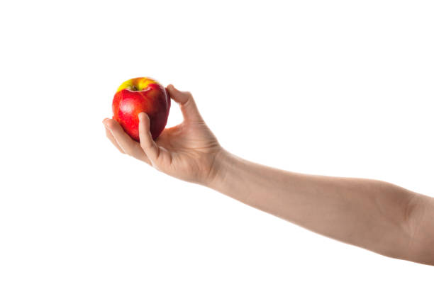 istock Apple. Male hand holding red apple. 700318670