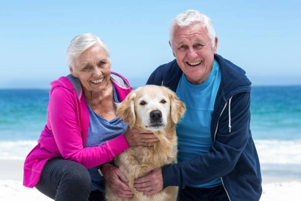 istock Cute mature couple petting their dog 700318976