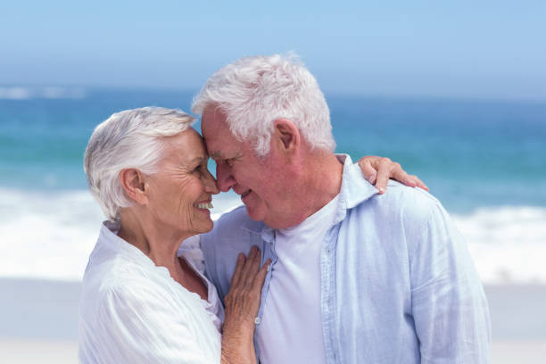 istock Senior couple smiling and embracing 700319410