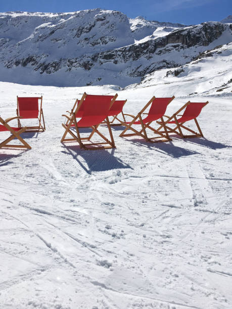istock Winter sunbathing, deck chairs in the snow 700325600