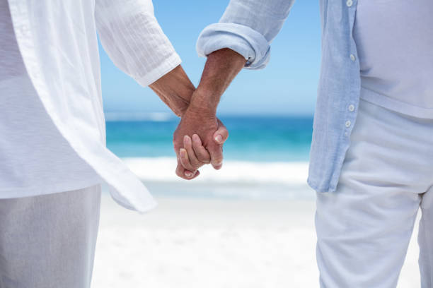 istock Senior couple holding hands 700341934
