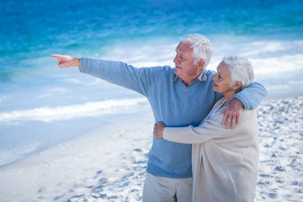 istock Senior couple embracing and pointing 700342134