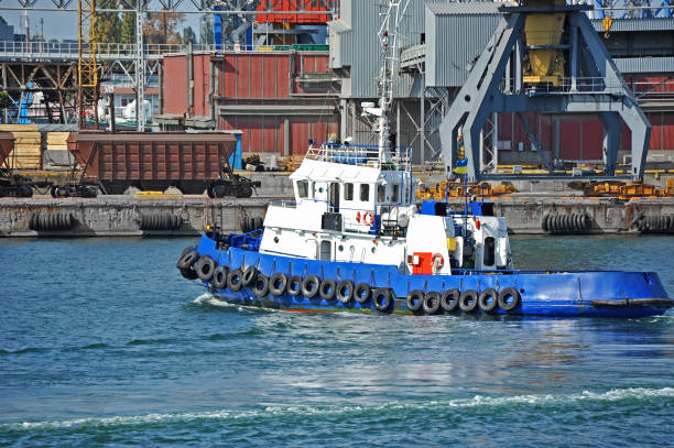 istock Tugboat and port cargo crane 700350530