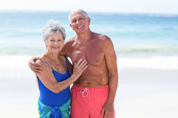 istock Cute mature couple embracing on the beach 700355260