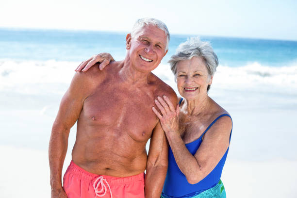 istock Cute mature couple embracing on the beach 700358638